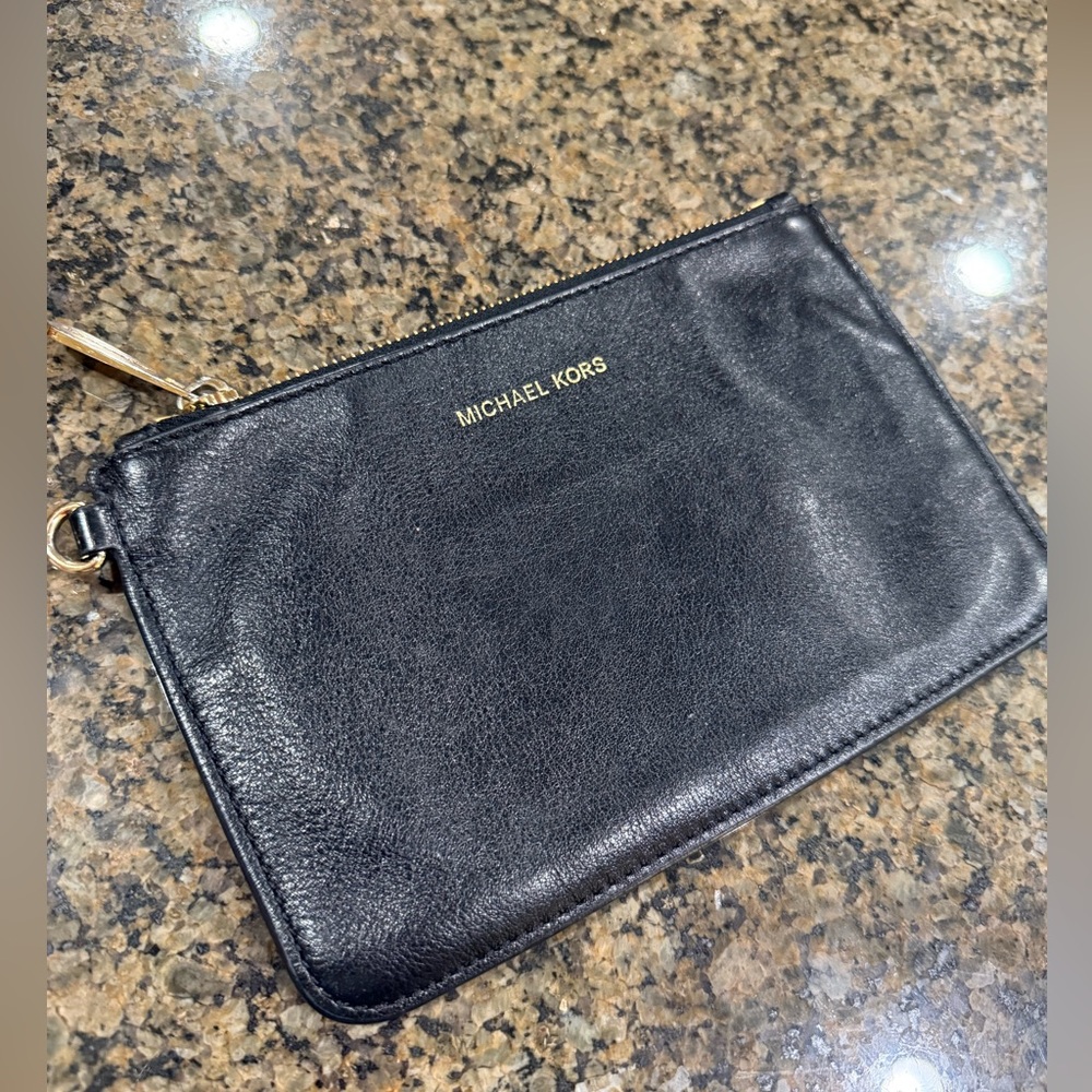 Authentic Michael Kors leather zip wristlet in black with golden hardware
